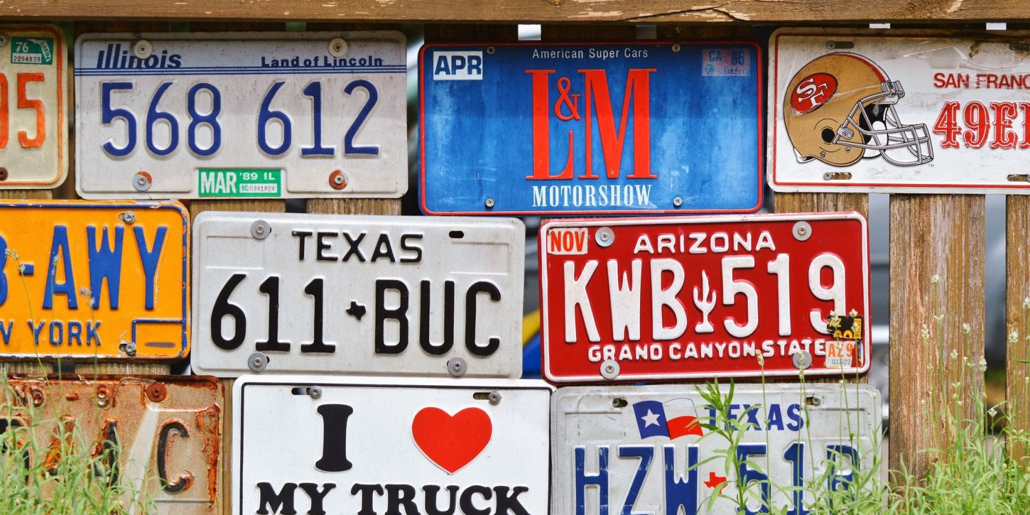 Various license plates on a wall