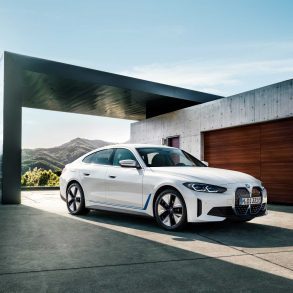 Three-quarter side view of a 2024 white BMW i4