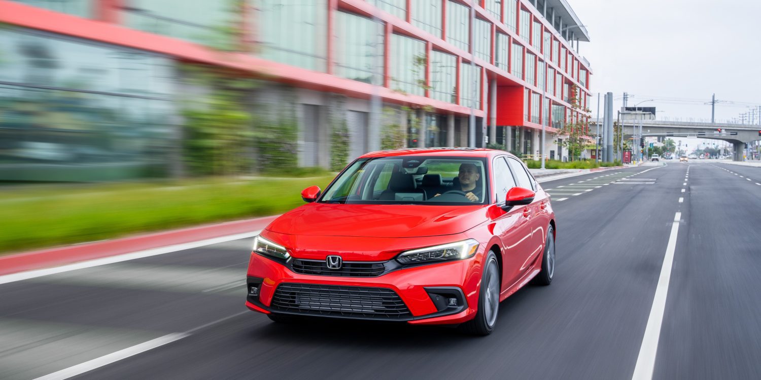 Front view of a 2024 red Honda Civic on a city street