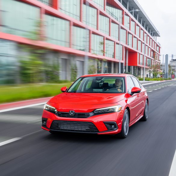 Front view of a 2024 red Honda Civic on a city street