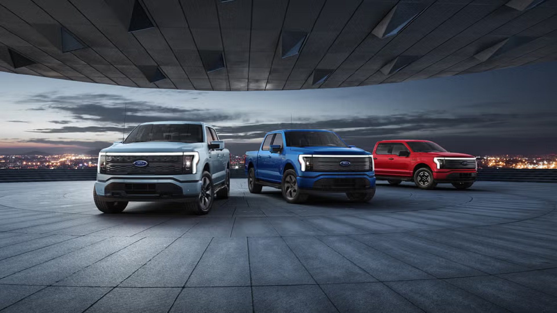 Image showing three Ford F-150 Lightning electric trucks.