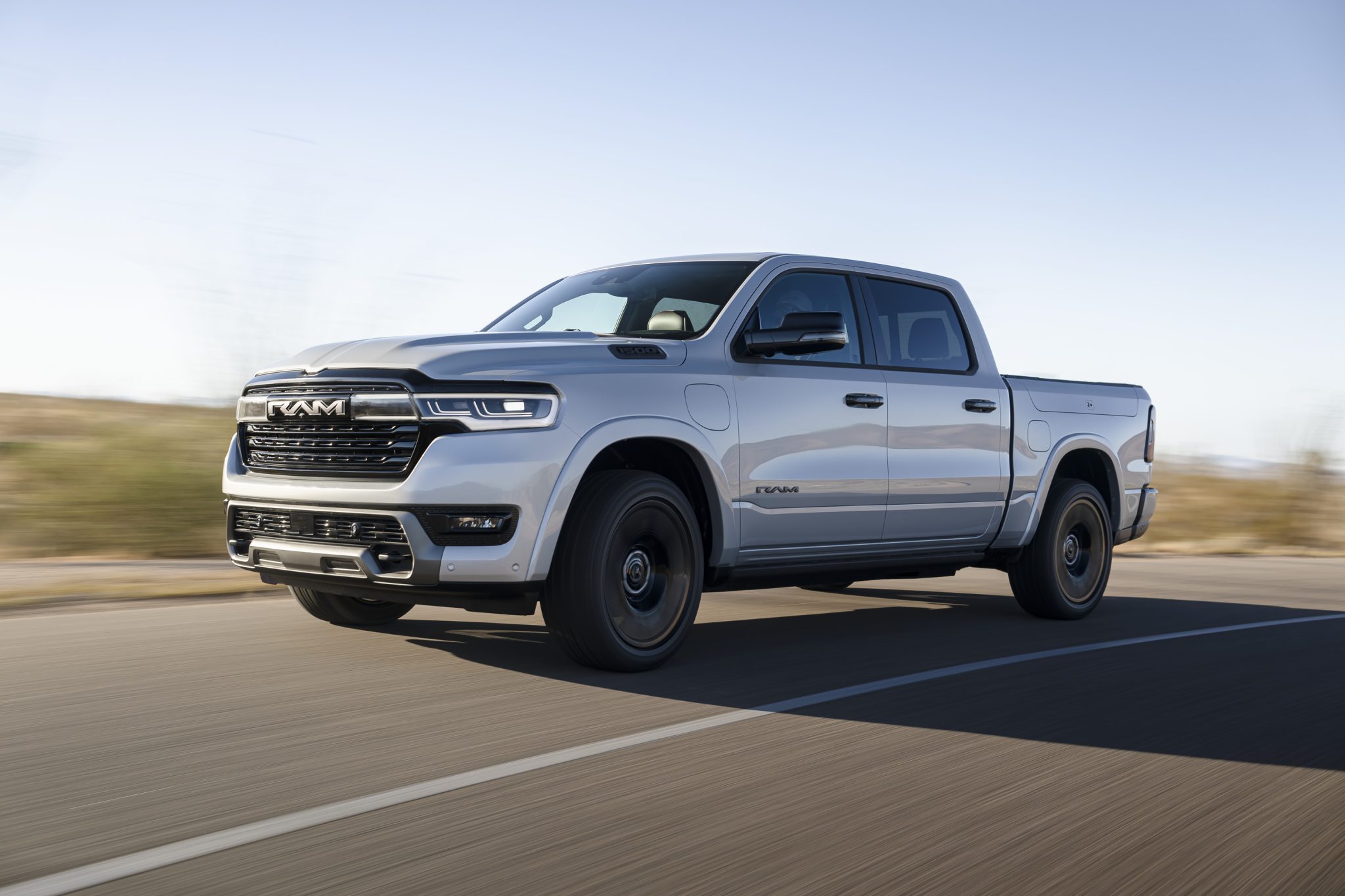 Three-quarter side view of a 2025 silver Ramcharger 1500