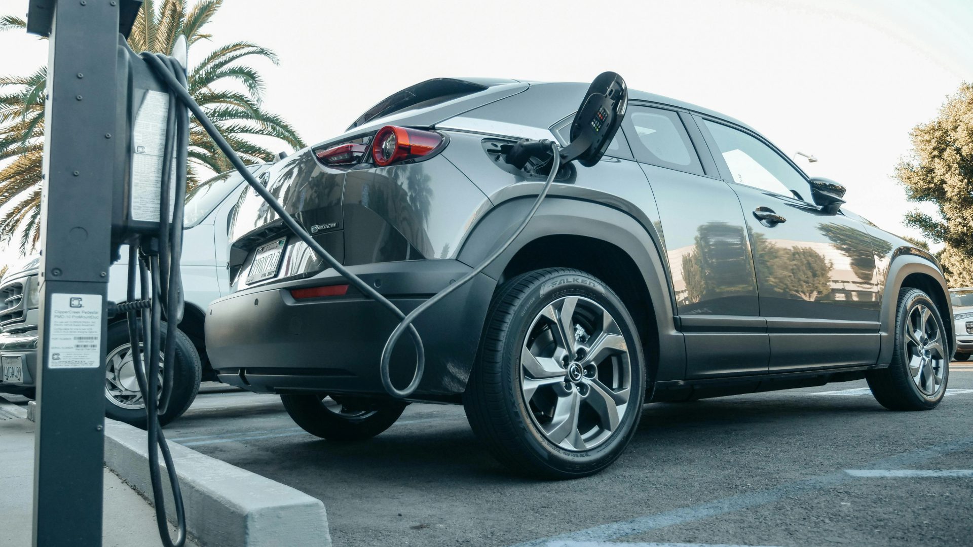 Mazda PHEV SUV recharging at charging station