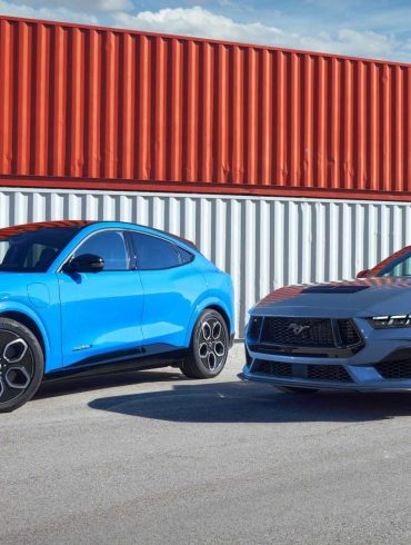 Three-quarter side view of a blue Mustang Mach-E and Mustang GT