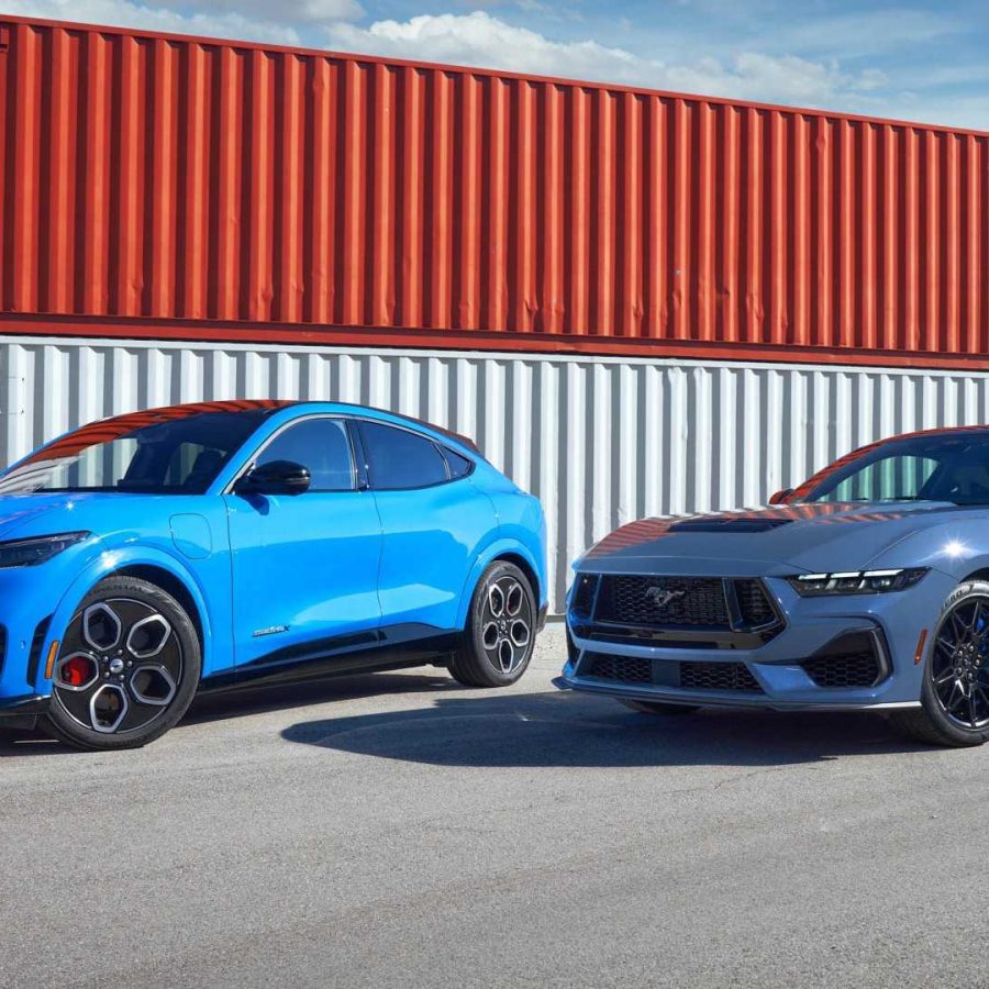 Three-quarter side view of a blue Mustang Mach-E and Mustang GT