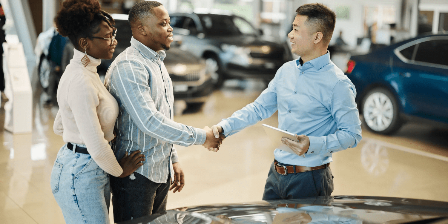 Couple buying a car at dealership