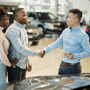 Couple buying a car at dealership