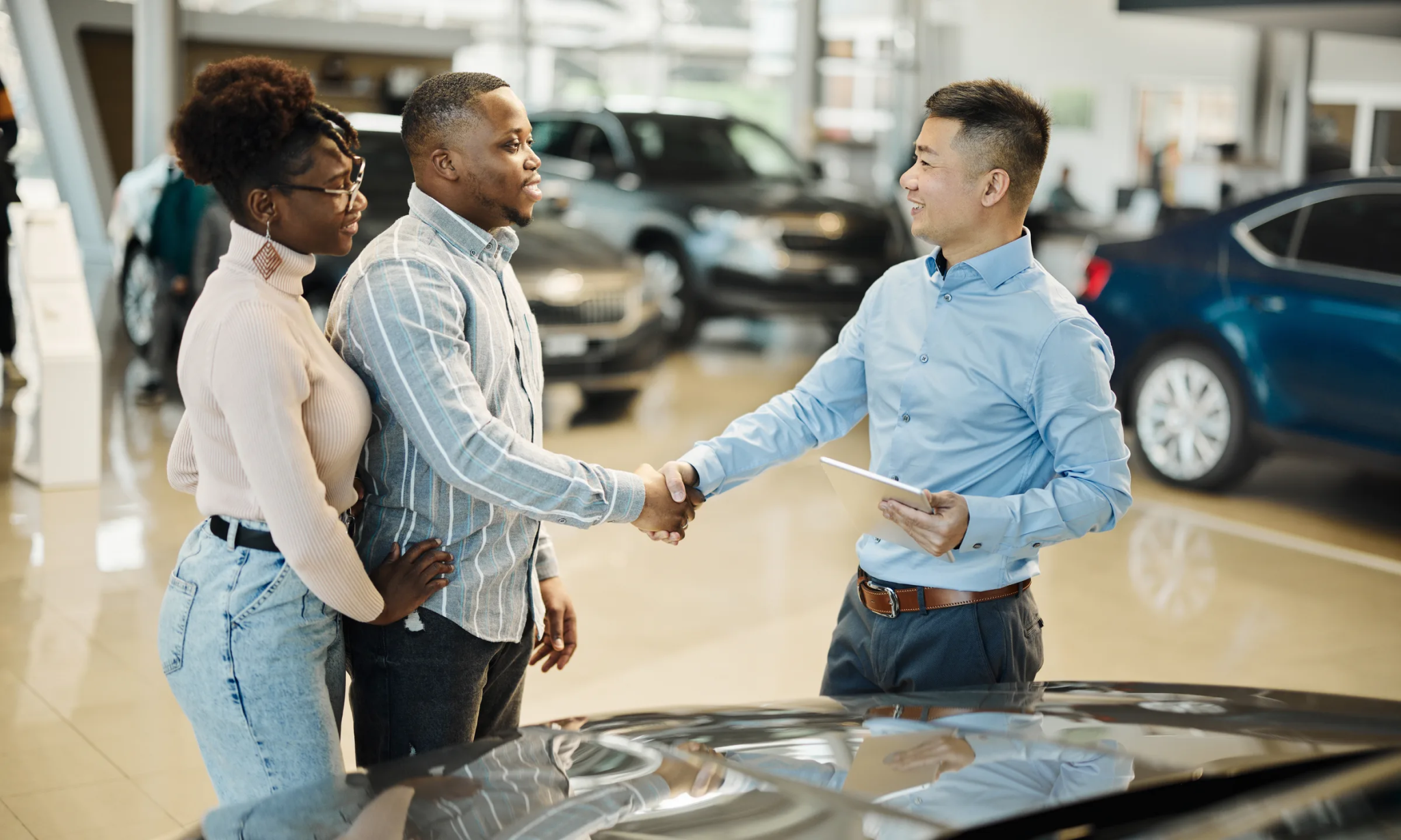 Couple buying a car at dealership