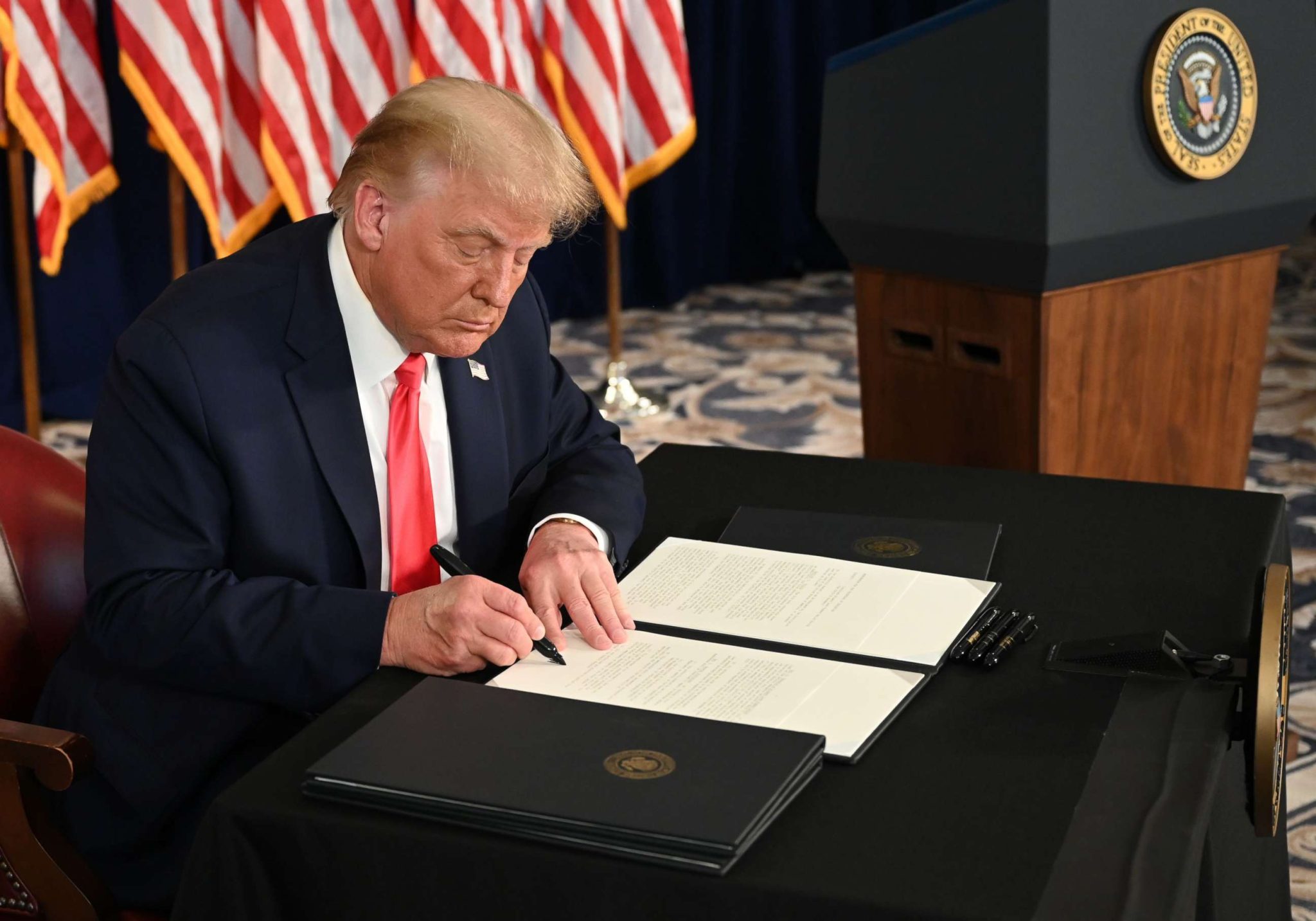 Trump signing an executive order